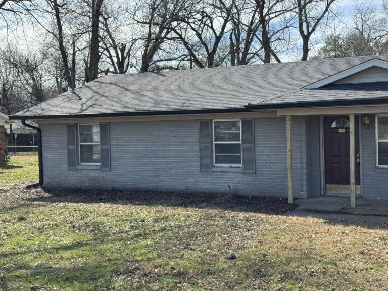 affordable-gutter-cleaning-home-with-gray-brick-exterior-and-garden