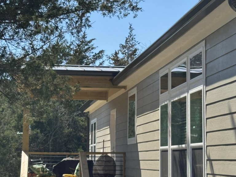 gutter-cleaning-home-with-porch-and-trees-in-background