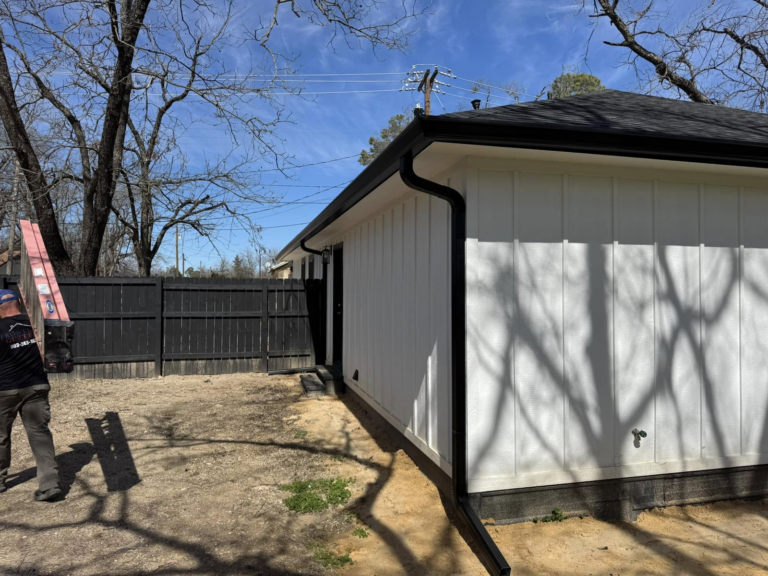 rain-gutter-replacement-backyard-house-with-ladder-and-fence