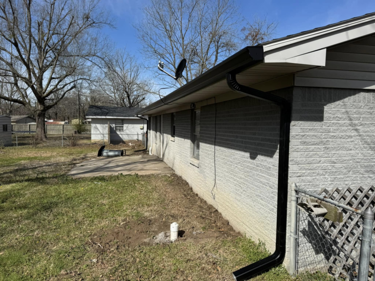 rain-gutter-replacement-in-front-of-house-with-yard