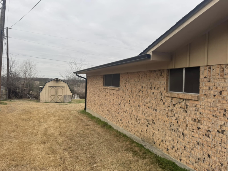 seamless-gutter-installation-on-brown-brick-house-siding