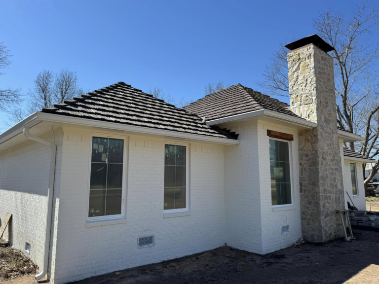 white-brick-house-with-roof-seamless-gutter-installation
