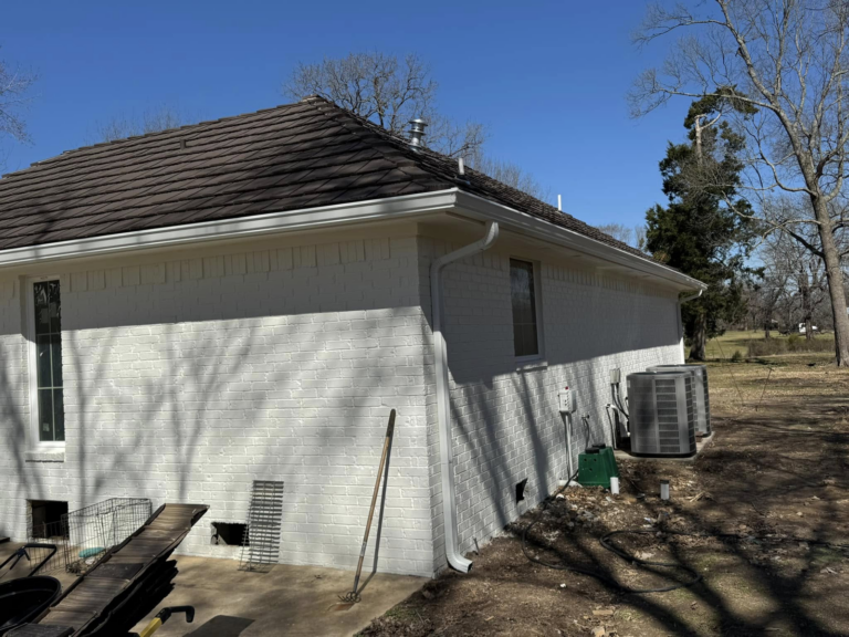 white-home-with-leaf-protection-systems-on-roof-and-gutters